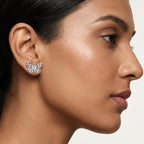 Close-up of a woman wearing a butterfly moissanite stud earring