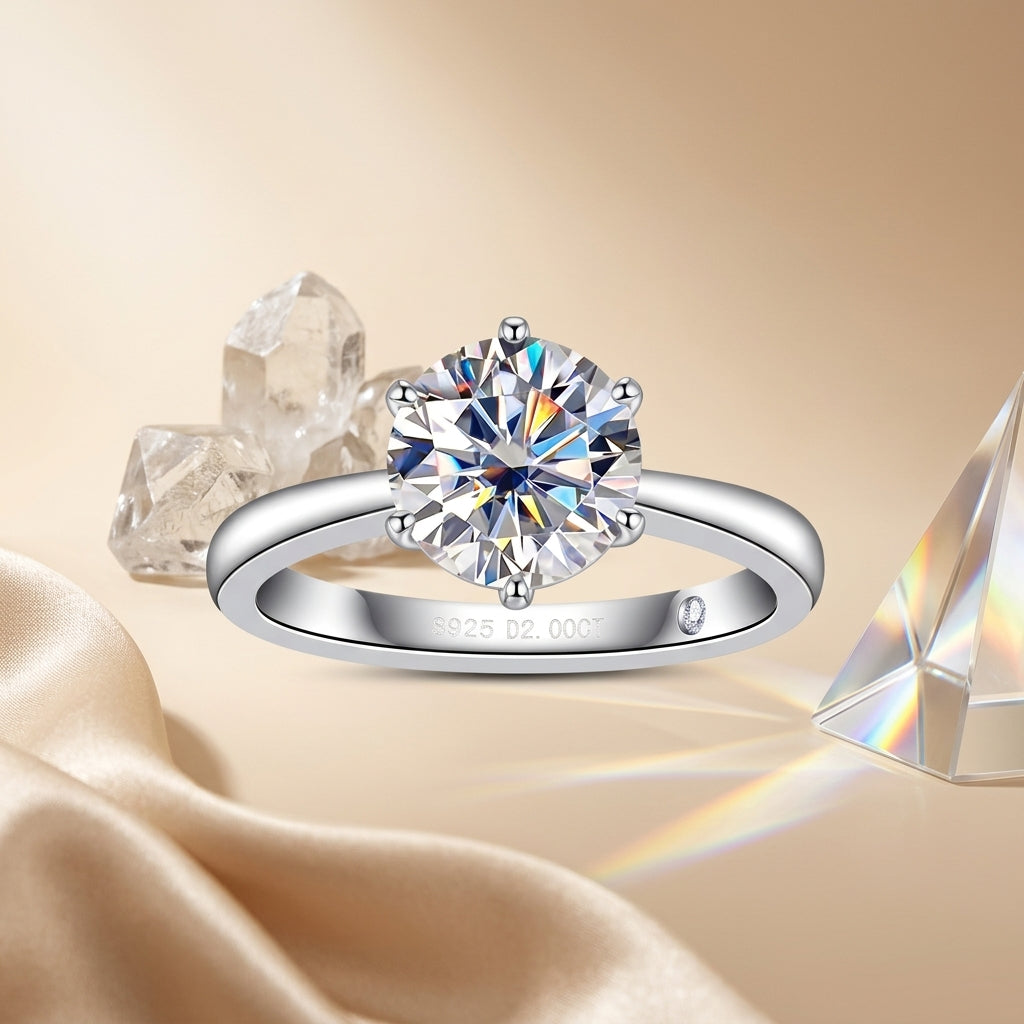 Round-cut moissanite solitaire ring displayed with crystals and champagne satin