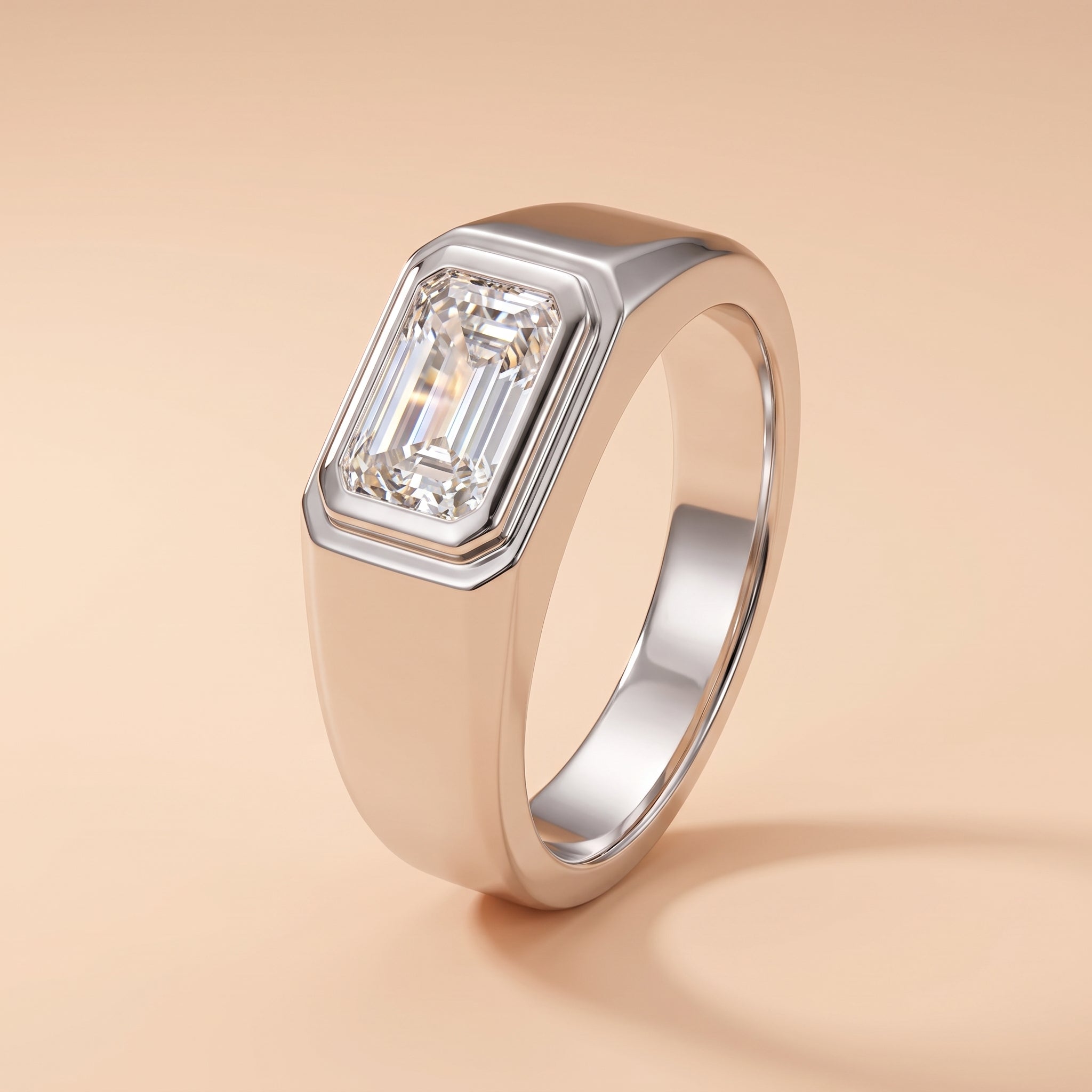 A silver-toned men's ring featuring a large rectangular emerald-cut diamond, shown on a warm beige background.
