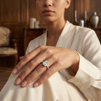 Woman wearing a 3 CT Asscher-cut moissanite engagement ring with a white outfit