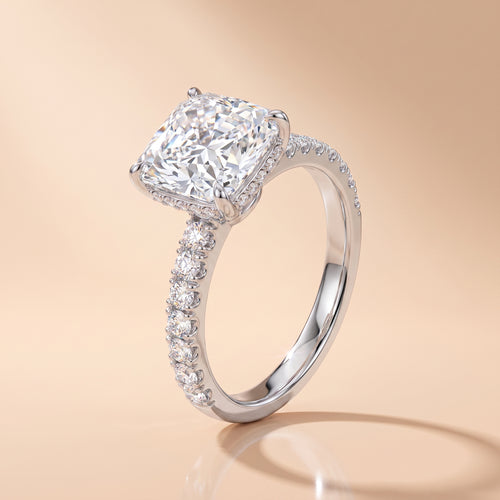 3 CT radiant-cut moissanite engagement ring with pavé band on a beige background