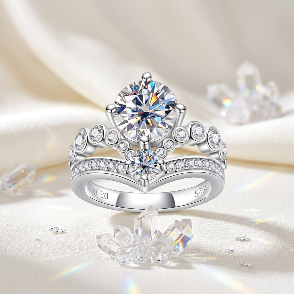Crown-style moissanite engagement ring displayed on cream satin with crystal accents