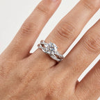 Close-up of a round-cut moissanite ring set worn on the hand