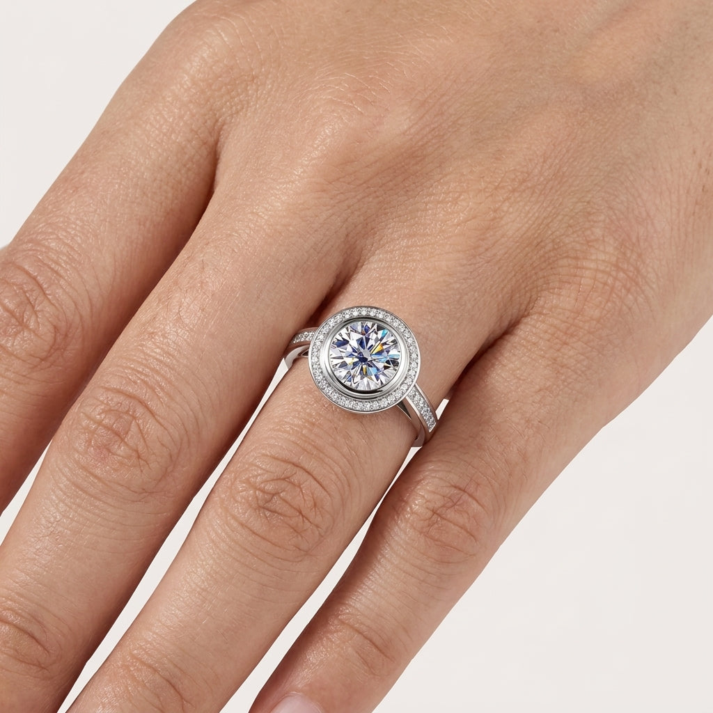 Close-up of a 3 CT round moissanite halo engagement ring worn on the hand