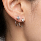 Close-up of 4MM moissanite hoop earrings worn with additional stud earrings