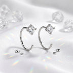 Pair of Montore 4MM moissanite hoop earrings displayed on white satin