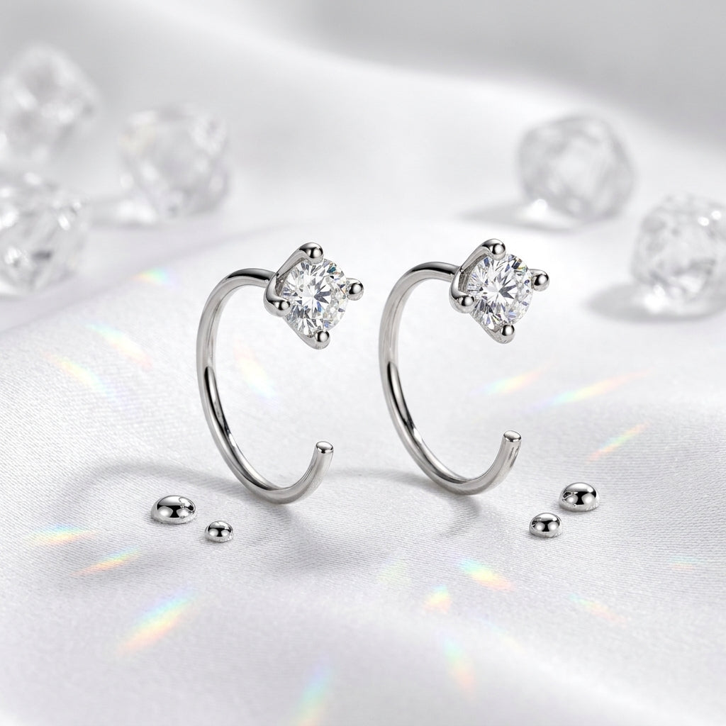 Pair of Montore 4MM moissanite hoop earrings displayed on white satin
