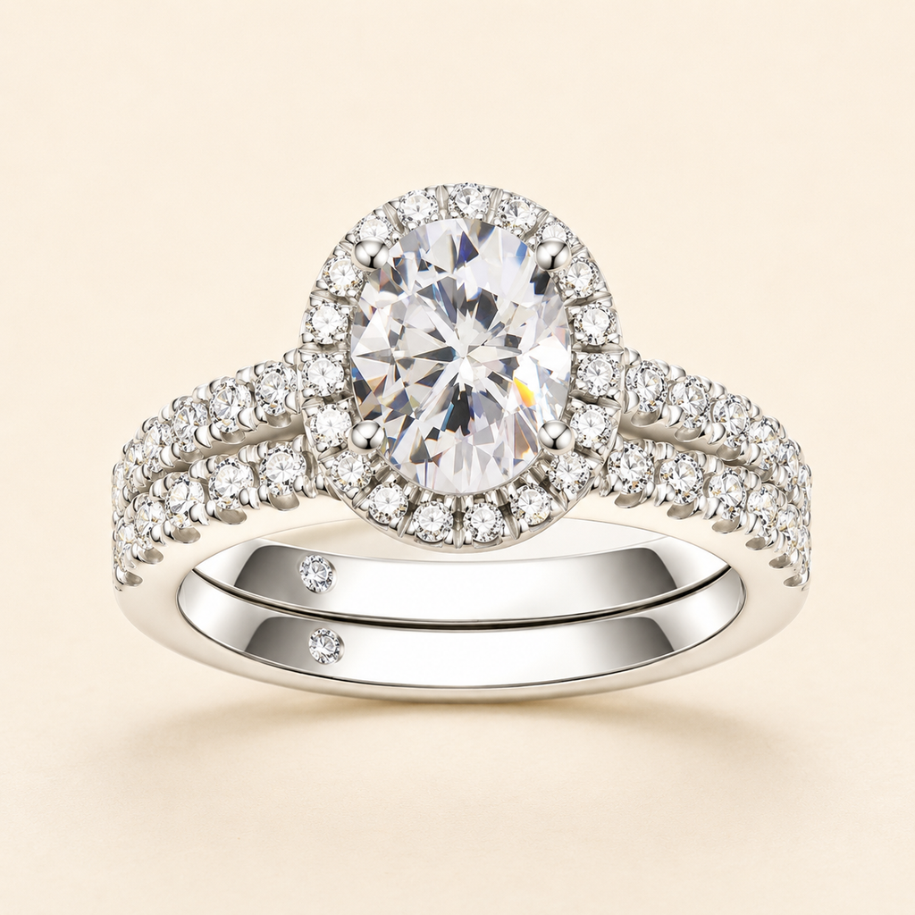 Front view of an oval-cut halo moissanite engagement ring with a matching pavé band