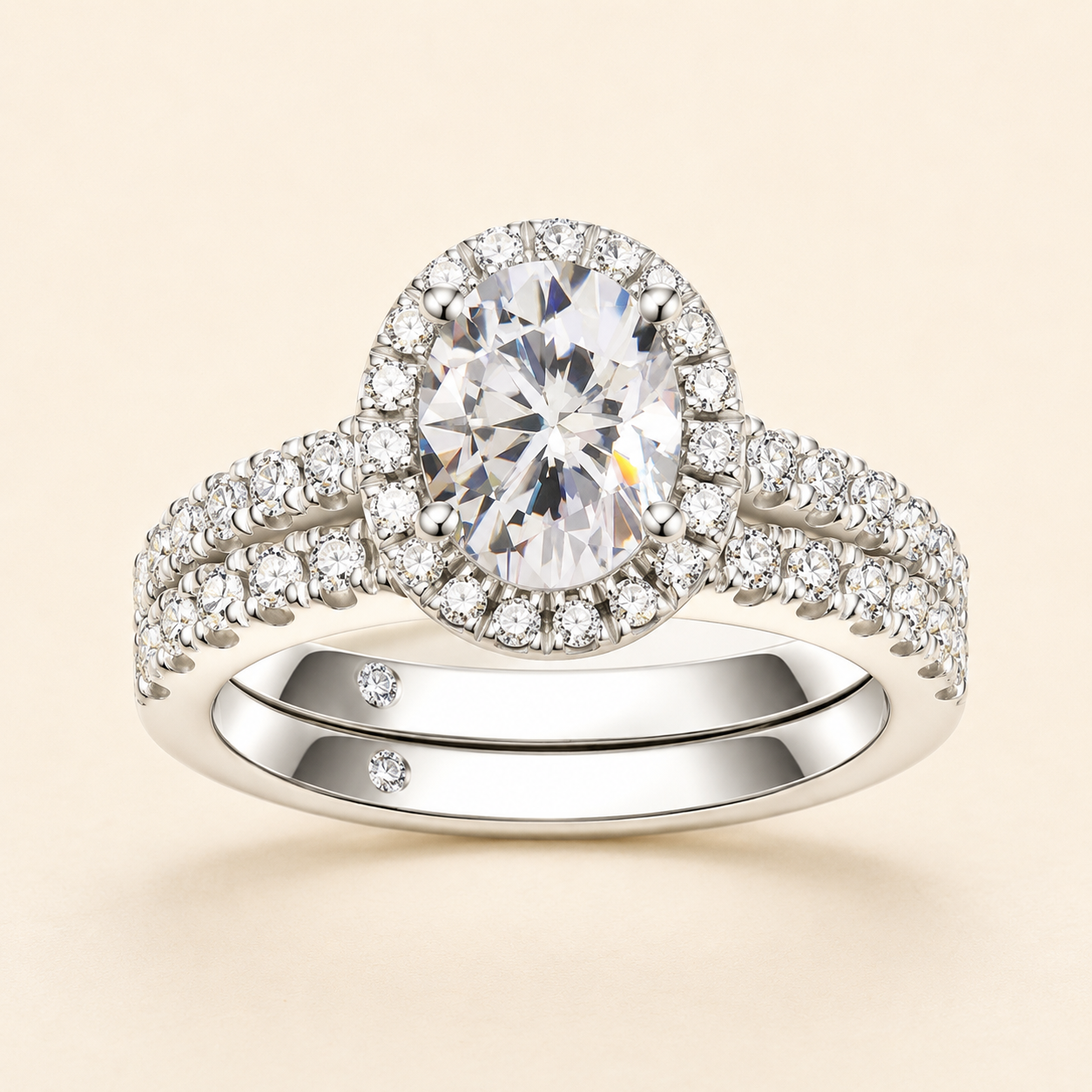 Front view of an oval-cut halo moissanite engagement ring with a matching pavé band