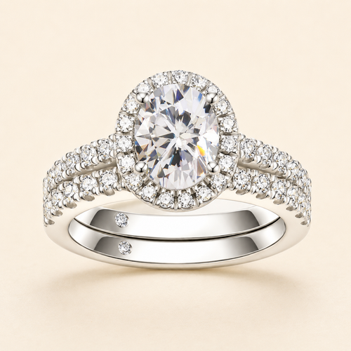 Front view of an oval-cut halo moissanite engagement ring with a matching pavé band