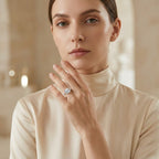 Model wearing a cushion-cut moissanite engagement ring with a cream outfit.