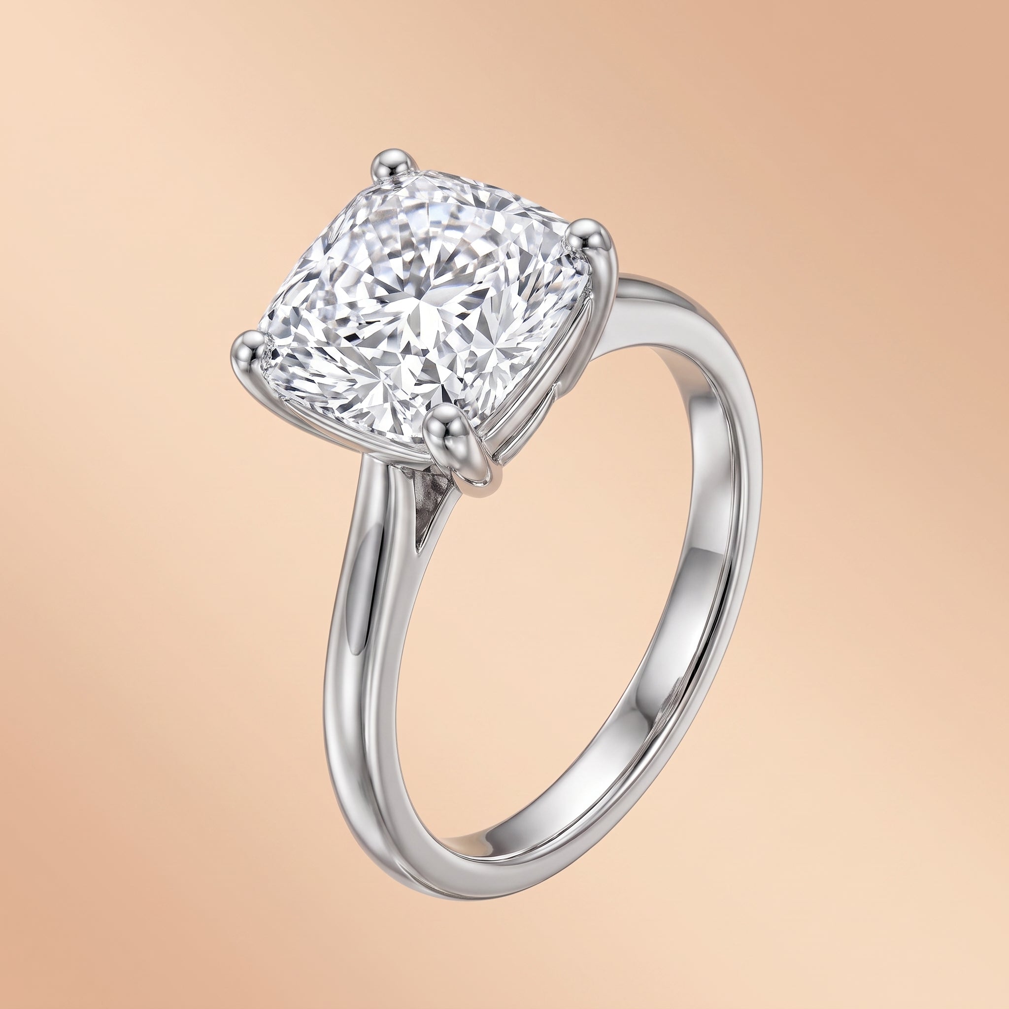 3.5 CT cushion-cut moissanite engagement ring in 925 sterling silver on a peach background.