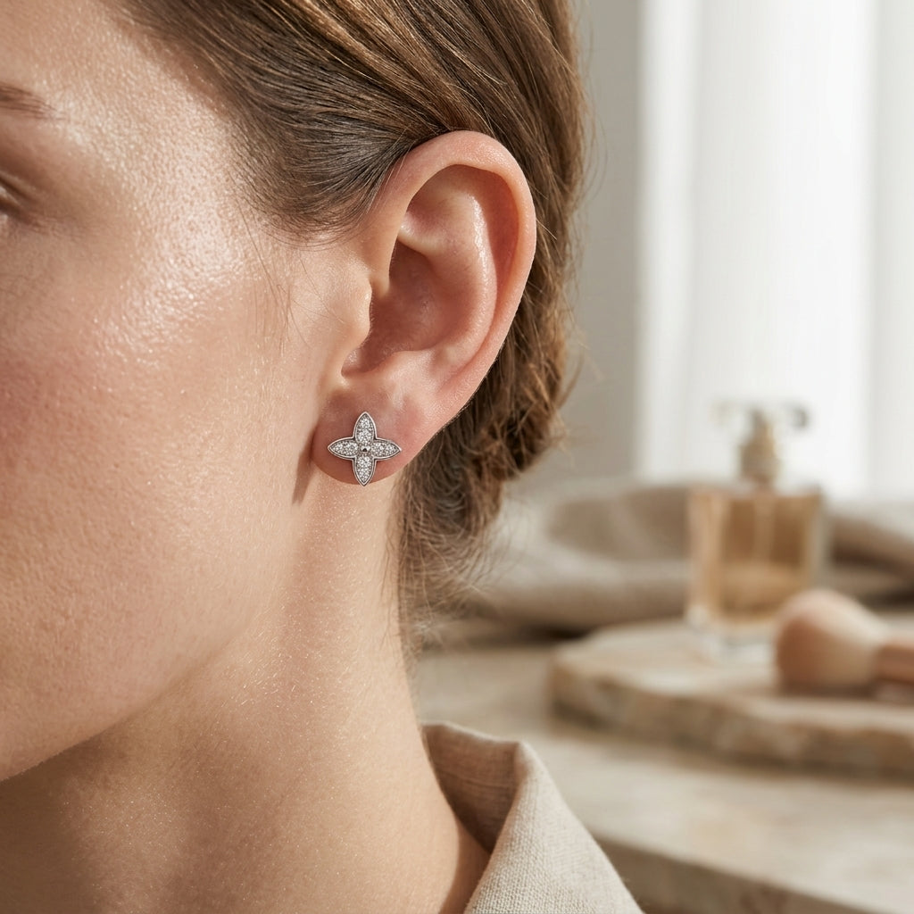Close-up of a woman wearing a four-leaf moissanite stud earring