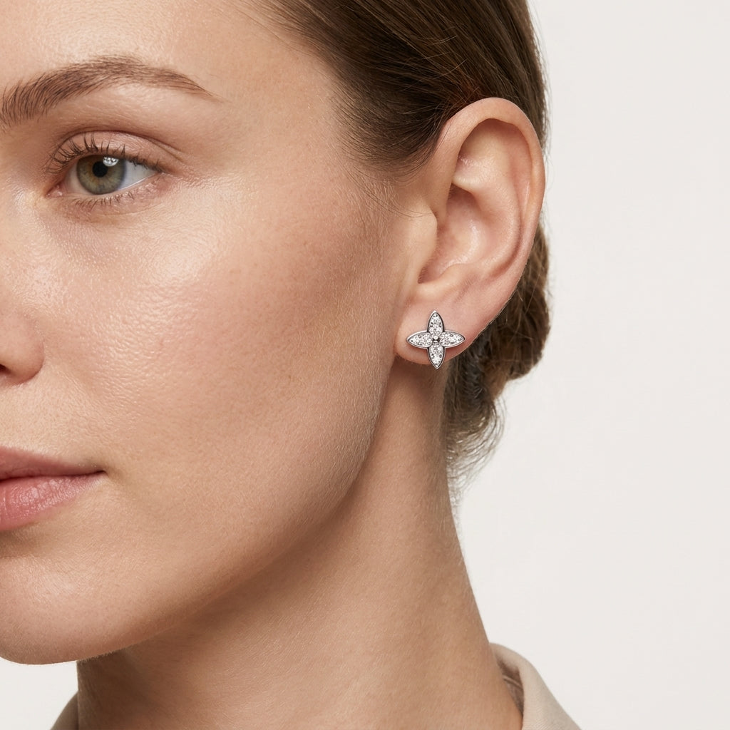 Side portrait of a woman wearing a four-leaf moissanite stud earring