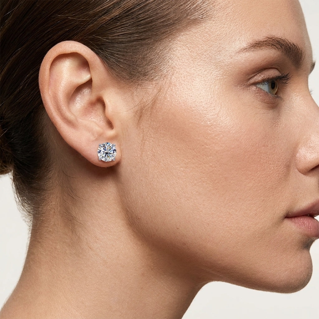 Woman wearing a round-cut moissanite stud earring in a close-up side profile