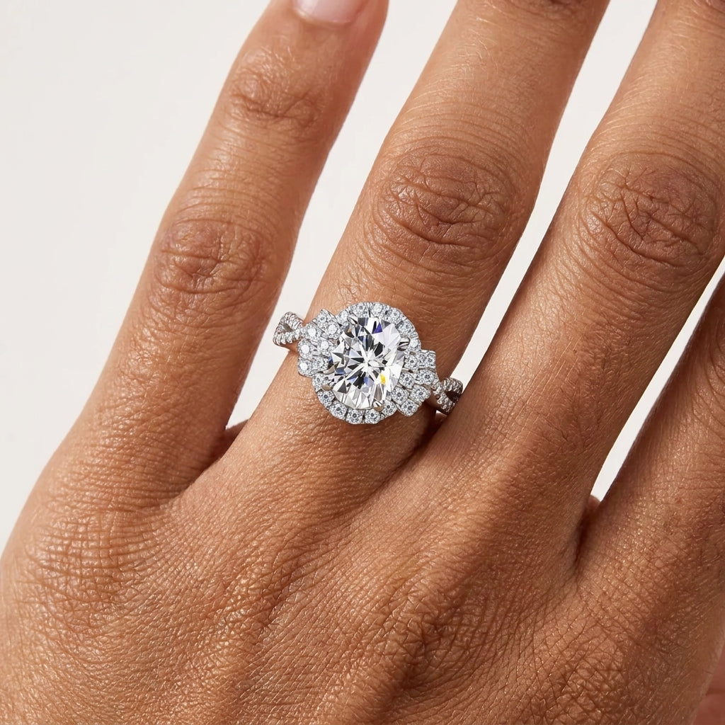 Close-up of a 2 CT oval moissanite halo engagement ring worn on the hand