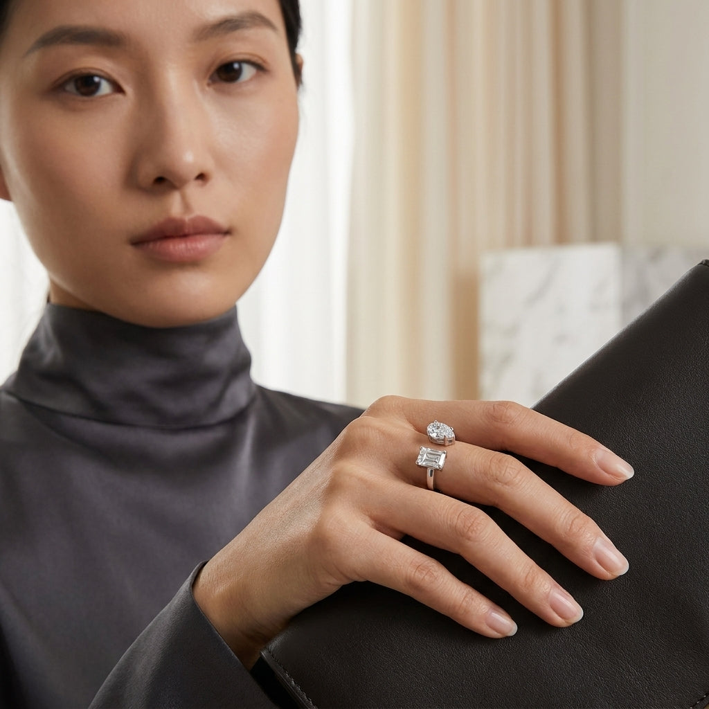 Woman wearing a twin-stone radiant and pear moissanite engagement ring